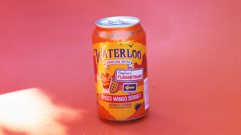 Can of mango sparkling water on backdrop
