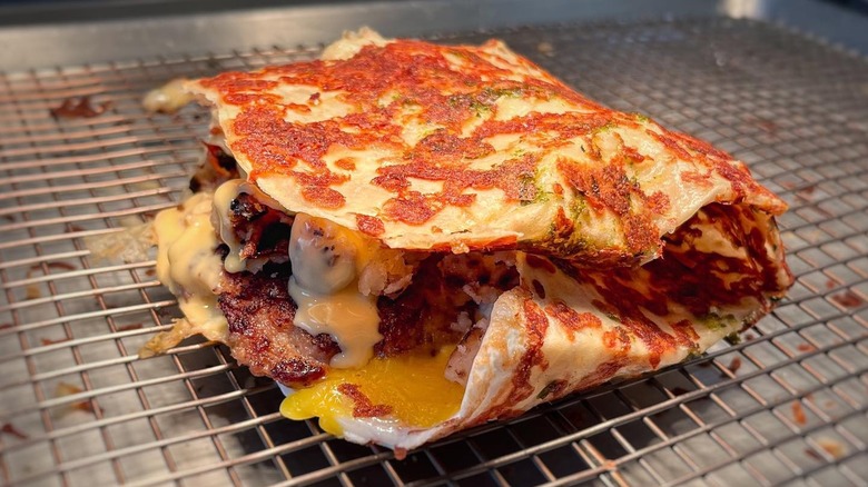 A stuffed crepe from Gabino's Creperie on a wire rack