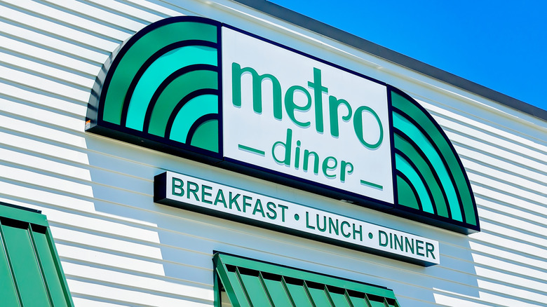 A Metro Diner logo on a building, with the words "breakfast, lunch, dinner" underneath