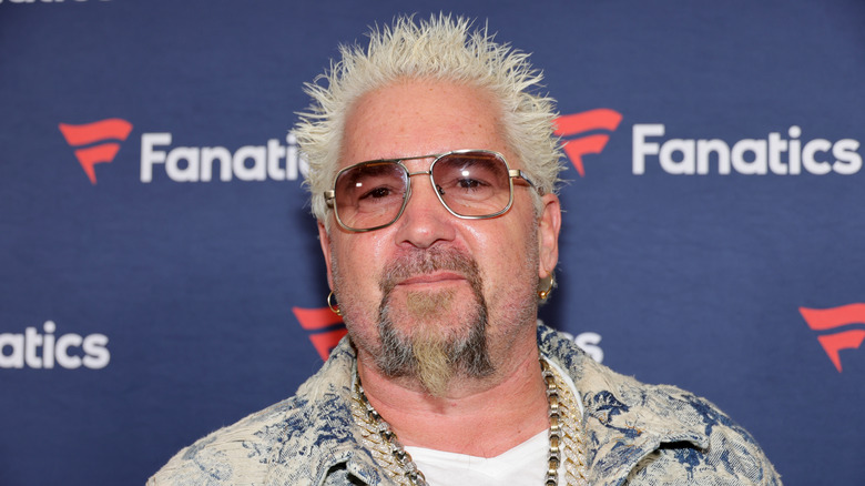 Guy Fieri smiling wearing sunglasses