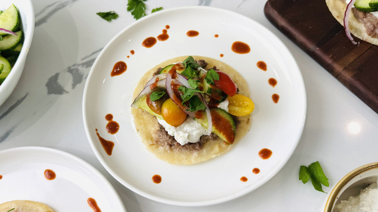 Gyro-style Greek taco on plate for serving