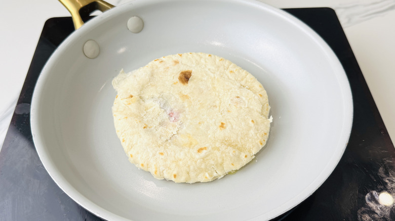 Lamb tortilla cooking meat side down
