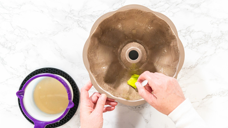 Person greasing a Bundt cake pan