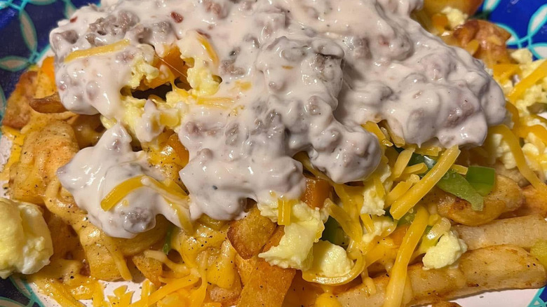 French fries covered with sausage gravy, eggs, and cheese