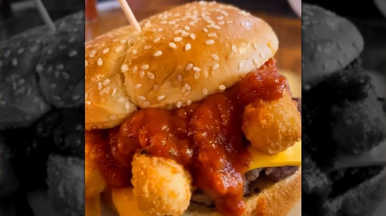 A burger topped with mozzarella sticks