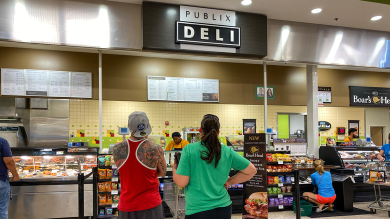 Customers looking at the Publix deli menu