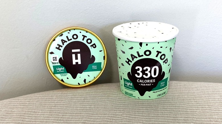 a tub of Halo Top Mint Chip ice cream open on a table