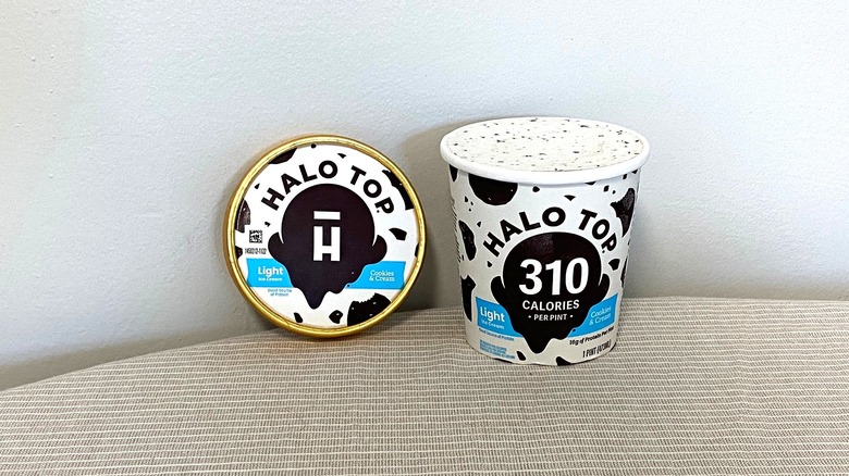 a tub of Halo Top Cookies and Cream ice cream open on a table