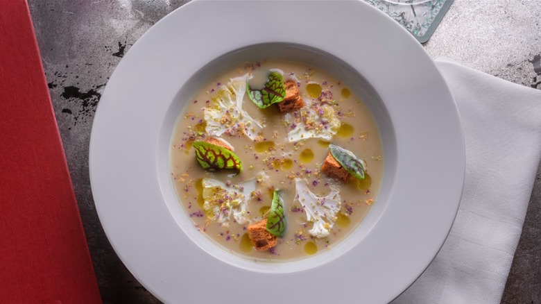 Velouté DuBarry — silken cauliflower, malt bread croutons, a stroke of balsamic in a white bowl