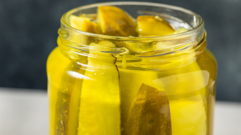 A jar of pickle spears inside pickle juice