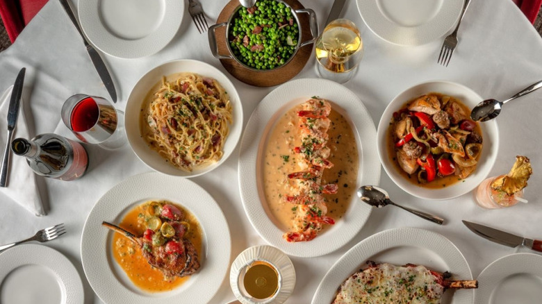 A white tablecloth set with plates and several of Rao's best dishes