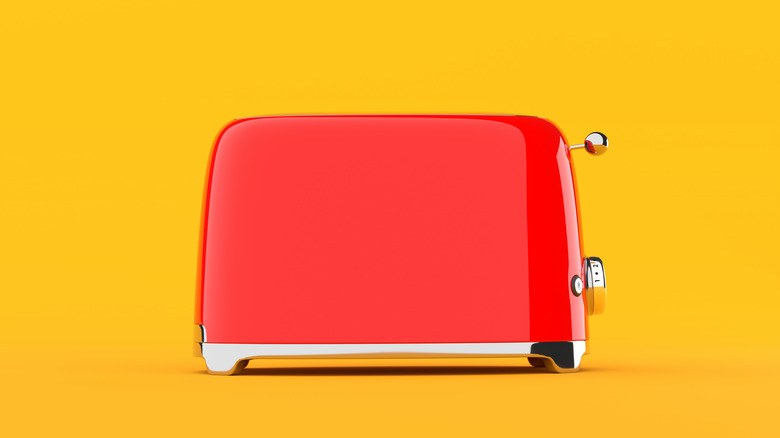 Red toaster on yellow background
