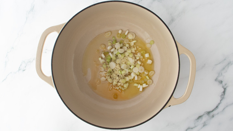 chopped onions and oil in a white pot