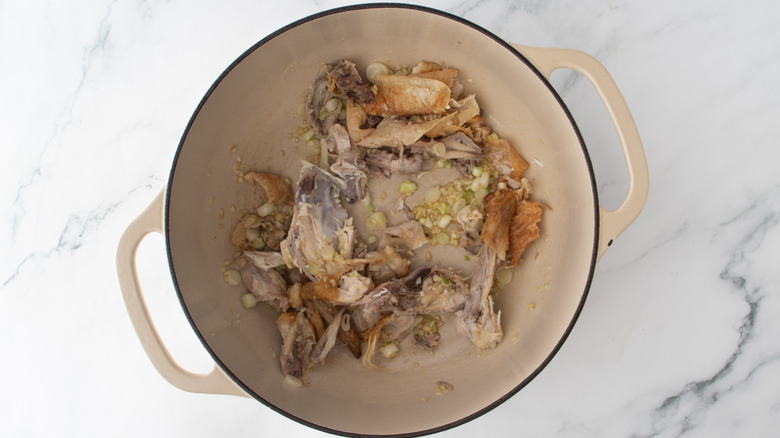 chicken bones and skin in a white pot