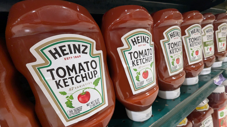 Bottles of Heinz ketchup lined up in a grocery store