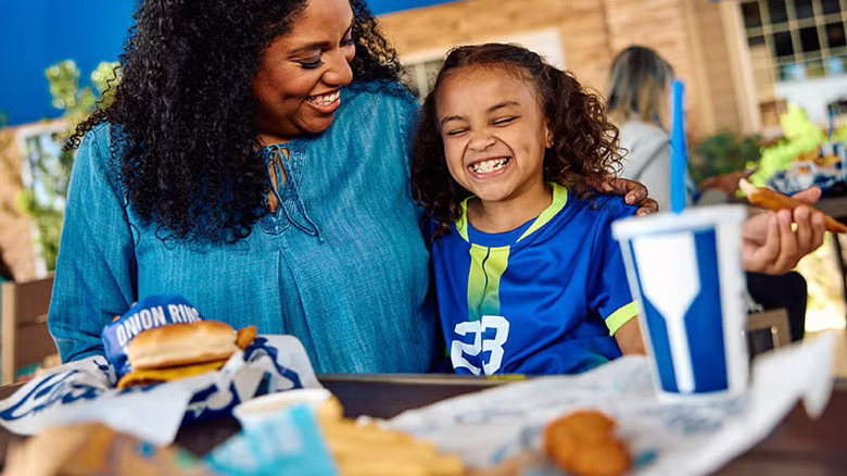 Adult and child at a table in the Culver's dining room