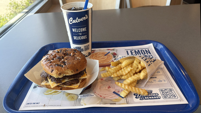 Culver's burger, drink, and fries on a tray with a liner advertising the rewards program