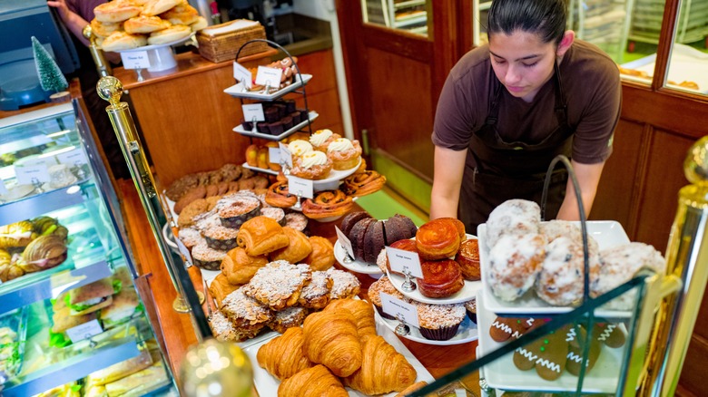 Worker arranging pastries at Bouchon