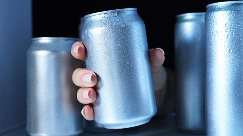 Person taking a beer out of the fridge