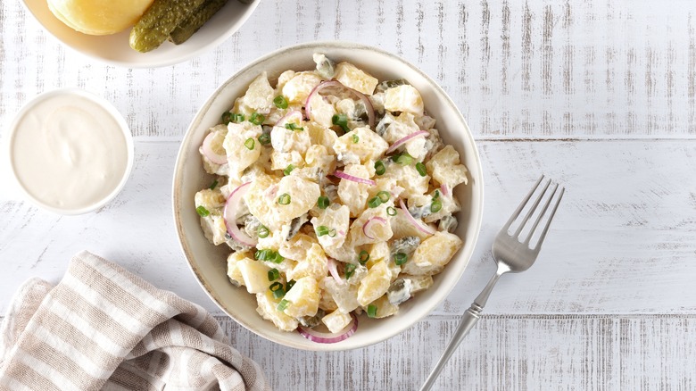 Potato salad in a bowl against a light background