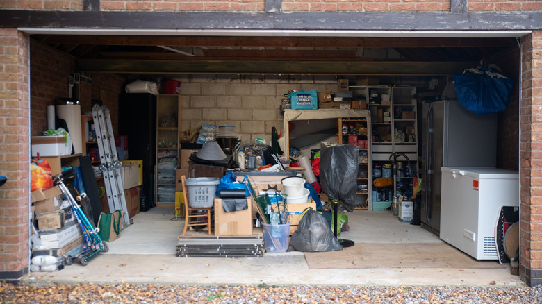 Open garage with many items, including a chest freezer