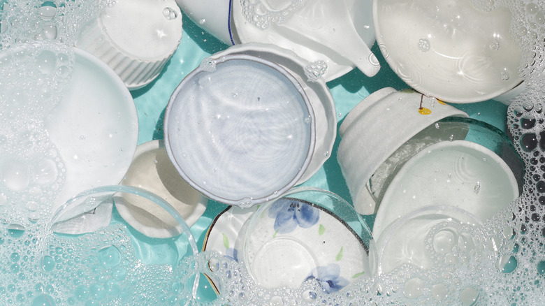 dishes submerged in soapy water