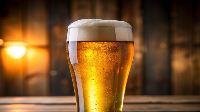 A glass of beer with visible foam on top