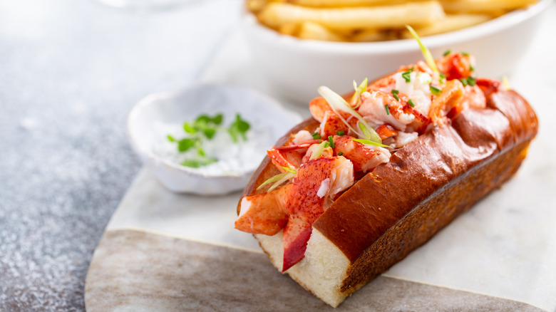 A lovely lobster roll is served simply in a split-top hot dog bun.
