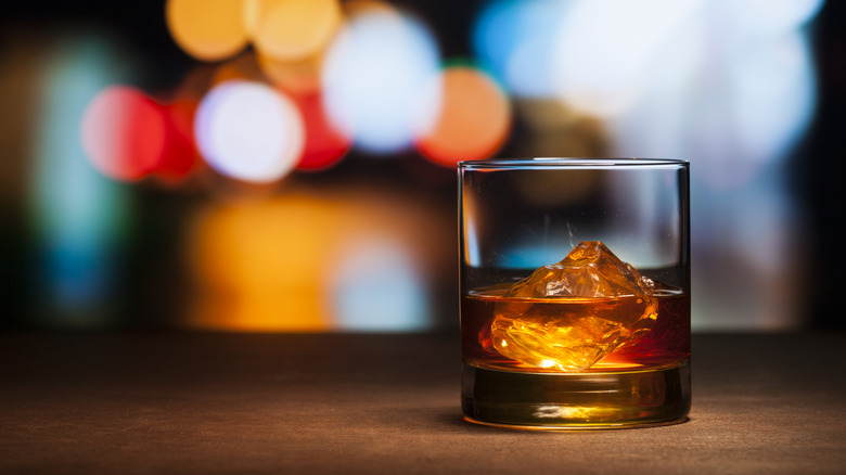 A glass of bourbon on a table