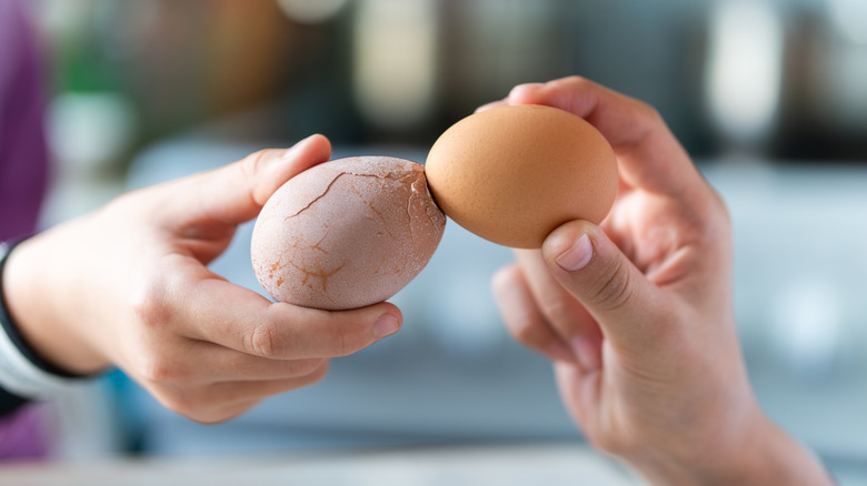 Cracking two eggs at once against one another