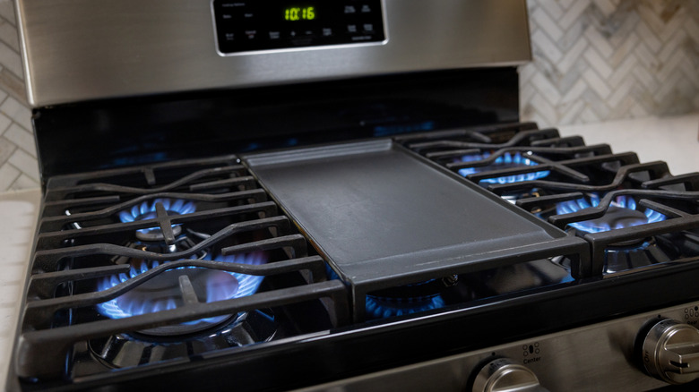 A gas stove with all burners ignited.