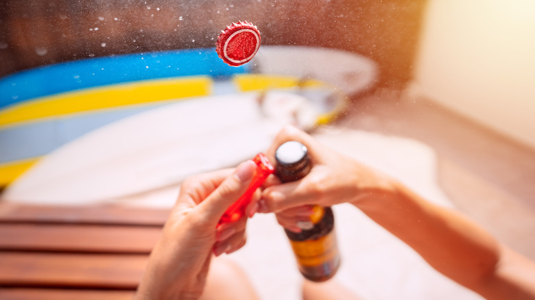 opening beer bottle with lighter
