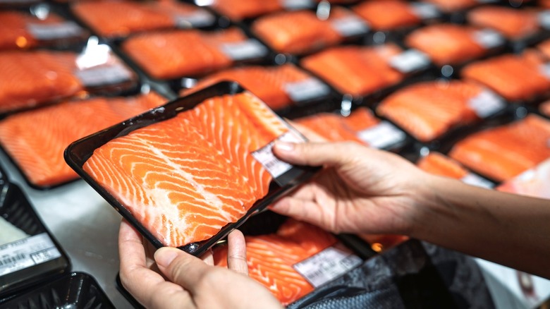 Shopping for pieces of packaged salmon