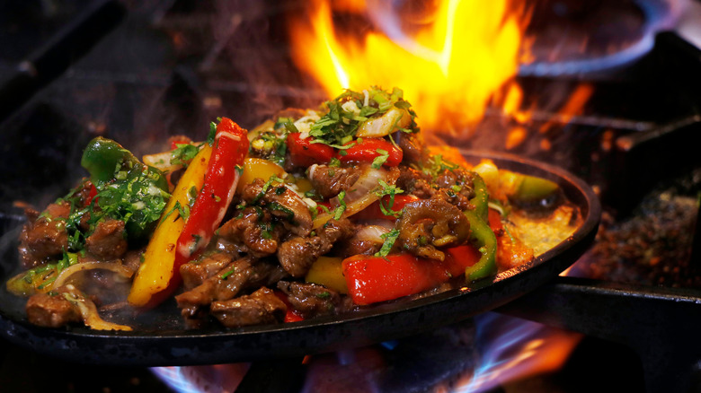 Sizzling fajitas on a cast iron skillet