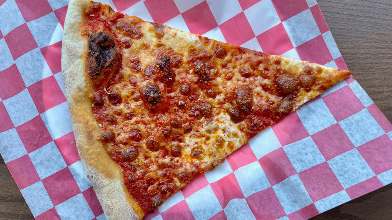 Simple slice of cheese pizza on a checkerboard paper