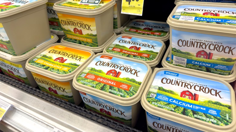 Packages of margarine in a supermarket refrigerator.