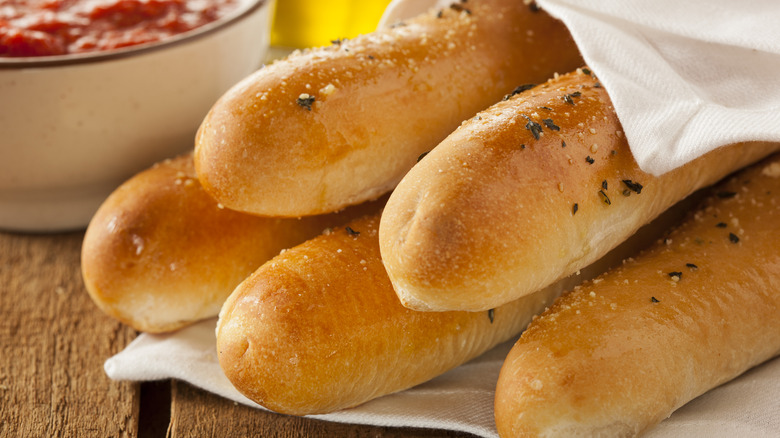 Close-up photo of breadsticks wrapped in white cloth