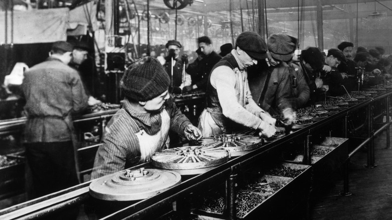 old photo of factory workers on an assembly line