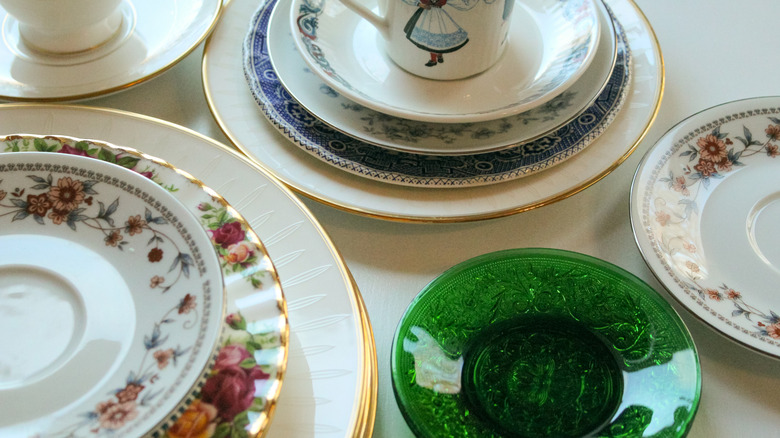 a random assortment of china plates and cups