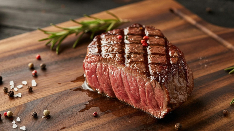 A juicy piece of steak on a wooden cutting board