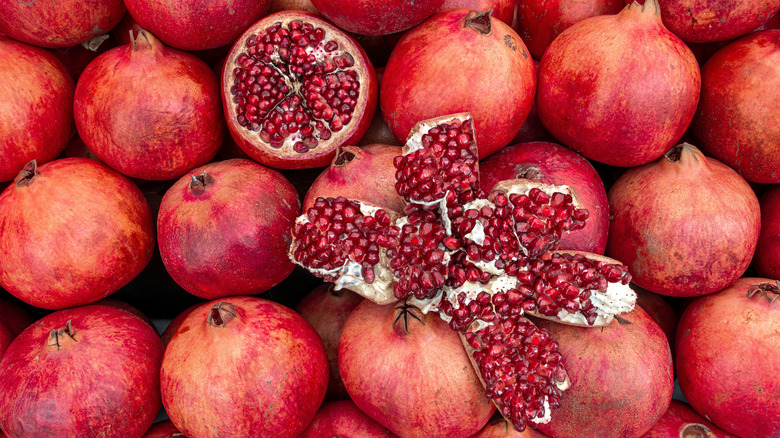 overhead view of whole and cut pomegranates