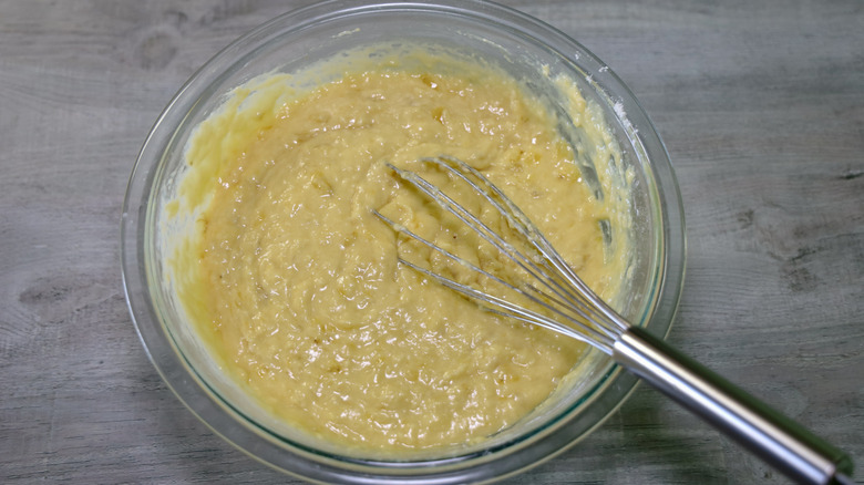 Banana bread batter in a glass bowl