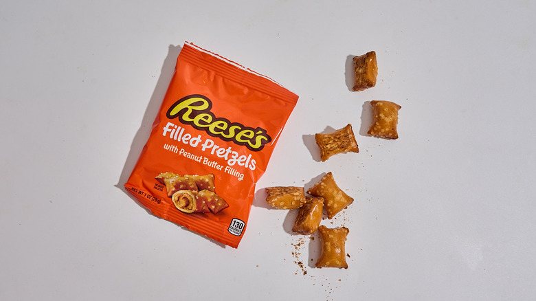 A package of Reese's Filled Pretzels on a table next to the pretzels