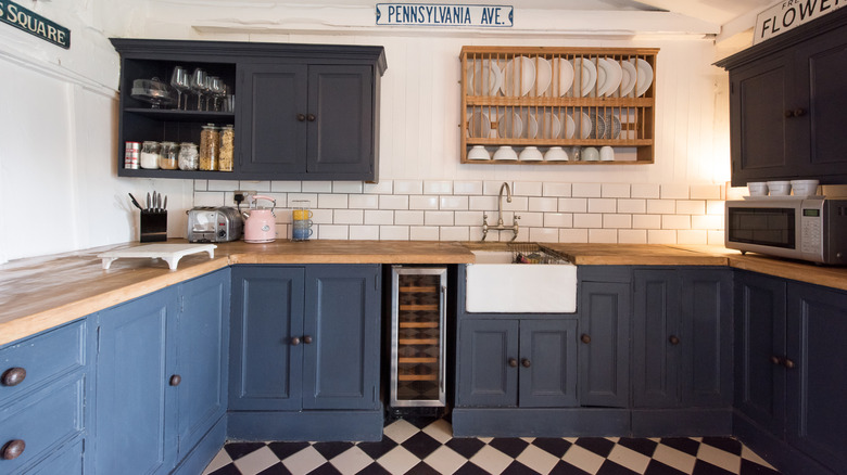 A kitchen with several colors and textures on various surfaces