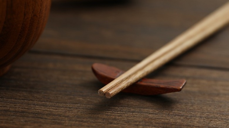 A pair of chopsticks placed neatly in the holder