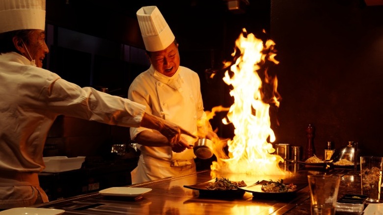 Teppanyaki chefs smiling as they cook
