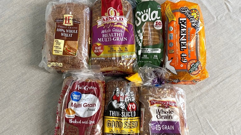 seven high-fiber breads arranged on a table