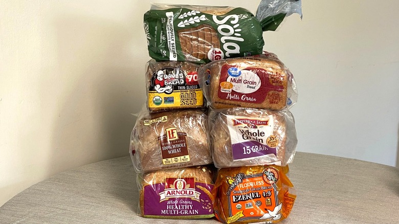 seven packages of high-fiber bread stacked on a table