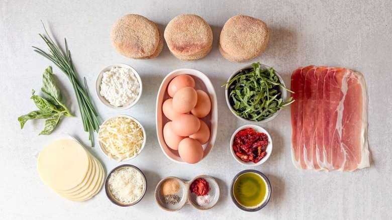 High-protein English muffin breakfast sandwich ingredients on countertop