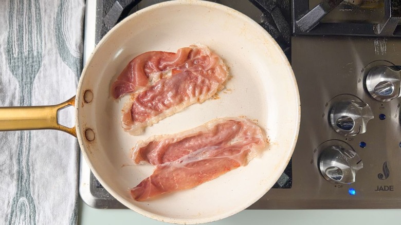 Prosciutto slices in skillet on stovetop